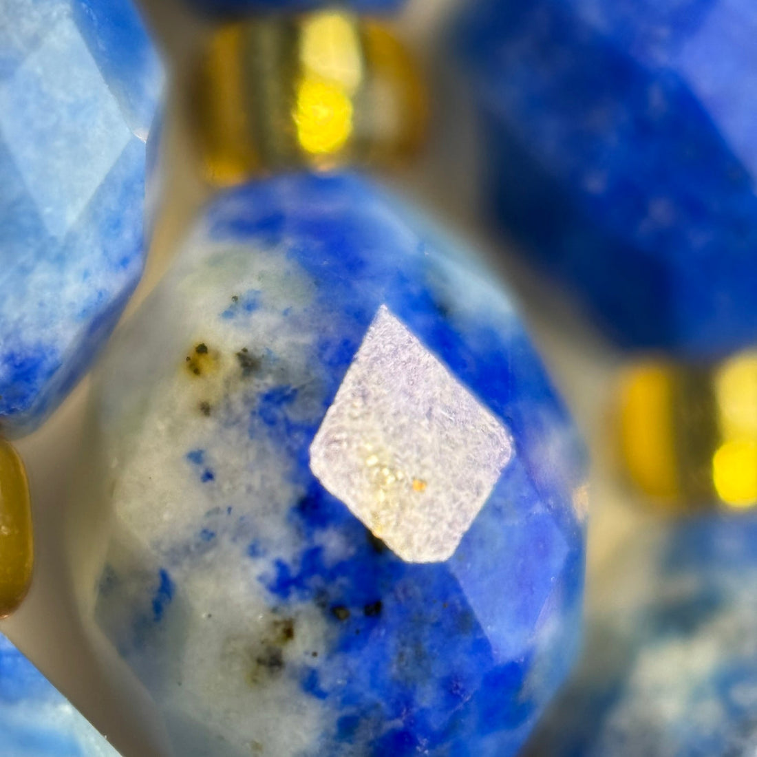 close up of faceted lapis lazuli stone beads in barrel shape with a sharp and zoom faceted