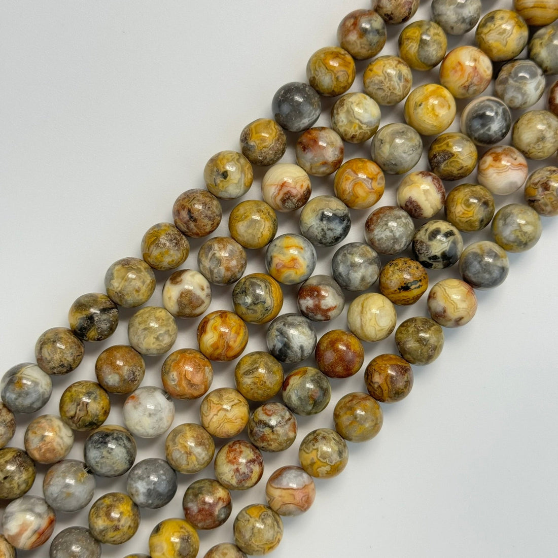 golden crazy lace agate gemstone beads in polished finish and round shape handpicked by reza piroznia gemmologist