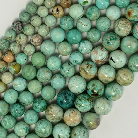 Turquoise - Origin is Peruvian the shape is round and the finish is smooth - handpicked by reza Piroznia