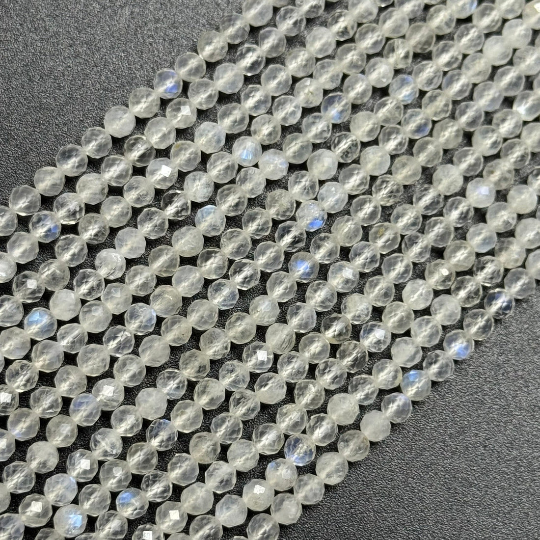 AAAA quality rainbow moonstone faceted round gemstone beads displaying natural blue adularescence