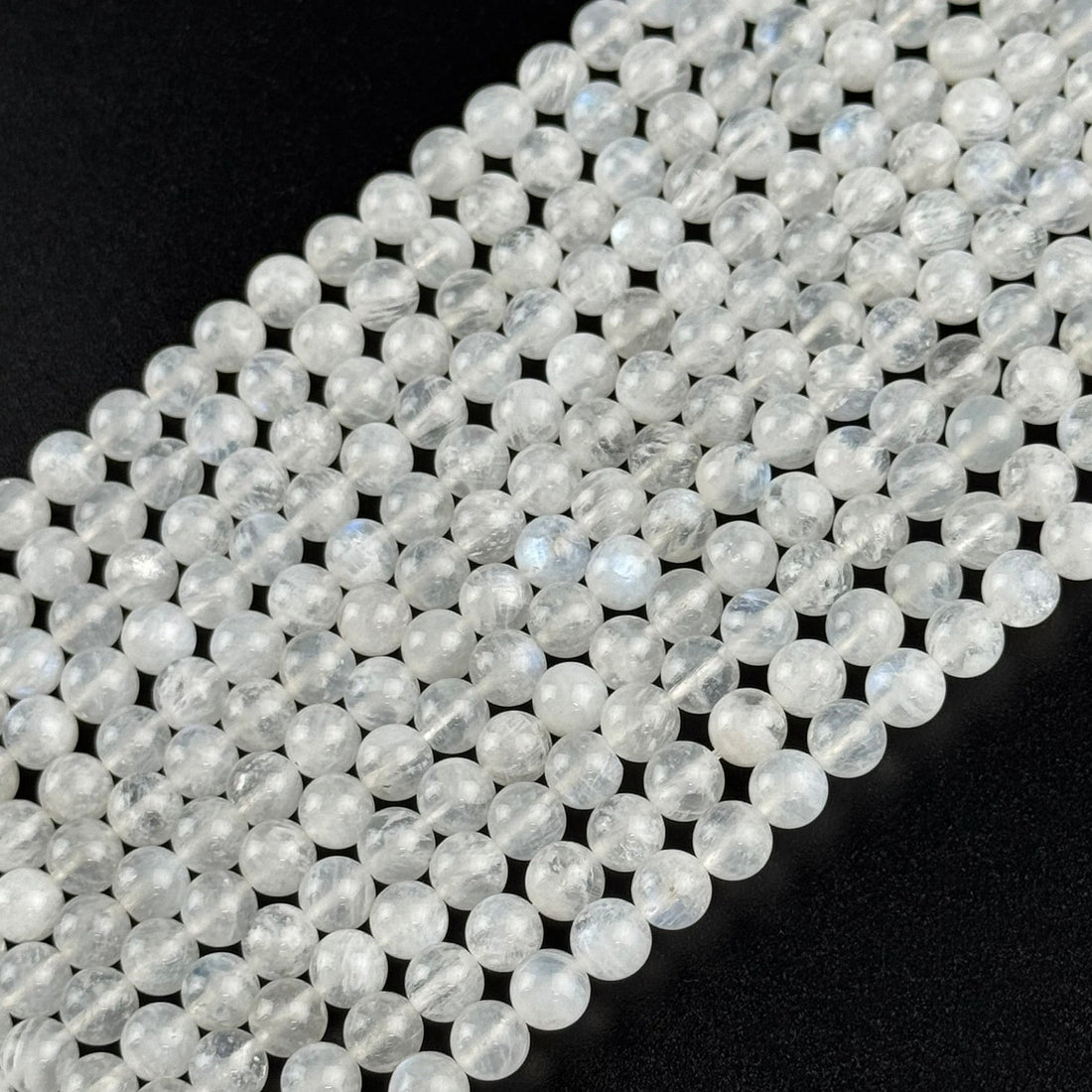 AAAA+ quality polished rainbow moonstone round gemstone beads displaying natural blue adularescence