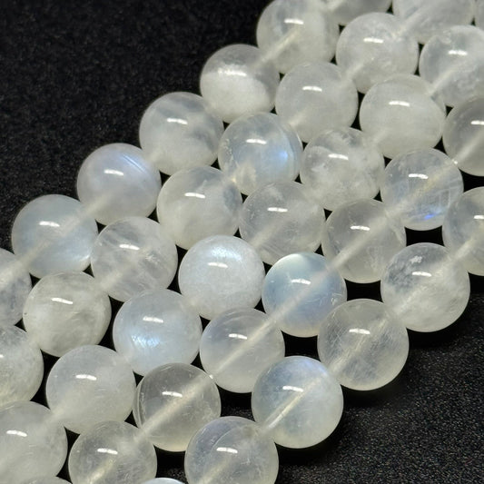 Natural rainbow moonstone displaying blue adularescence in polished gemstone beads