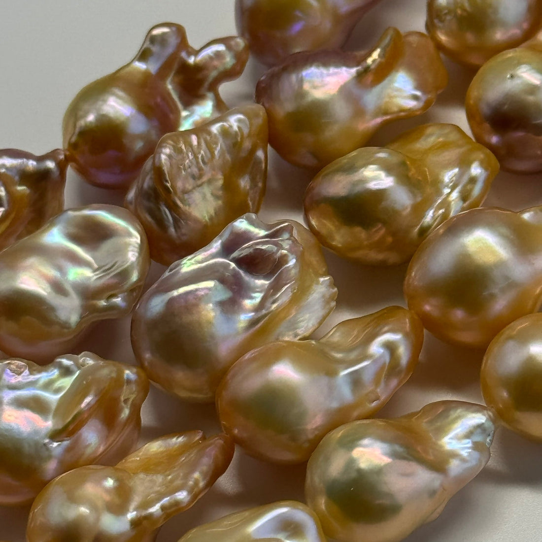 Freshwater cultured pearl necklace being gently cleaned with a soft cloth to protect the pearls' natural luster.