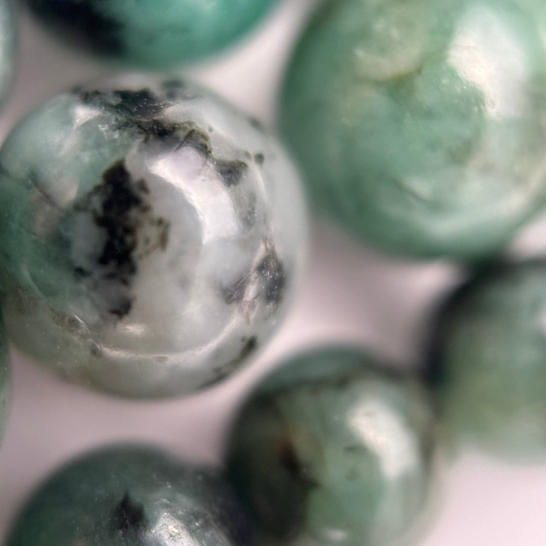 Natural emerald gemstones showing green color, inclusions and internal features examined when identifying real emerald.