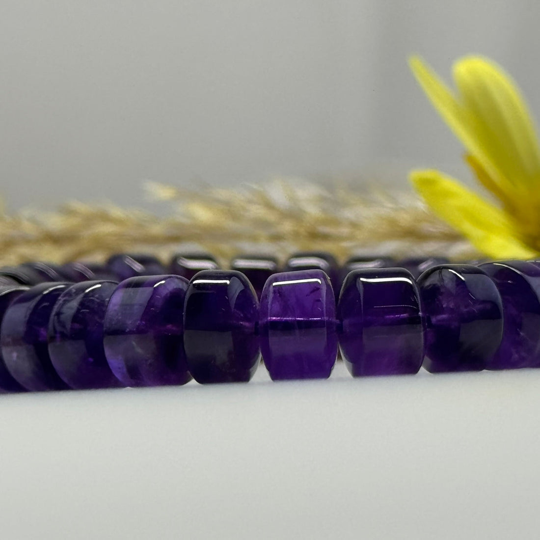 Different types of natural amethyst showing deep purple, lavender, chevron and color-zoned amethyst crystals and gemstones.
