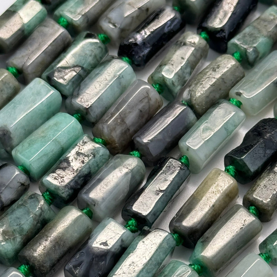 Natural emerald gemstones showing Colombian, Zambian and other emerald colors, inclusions, transparency and green color variations.