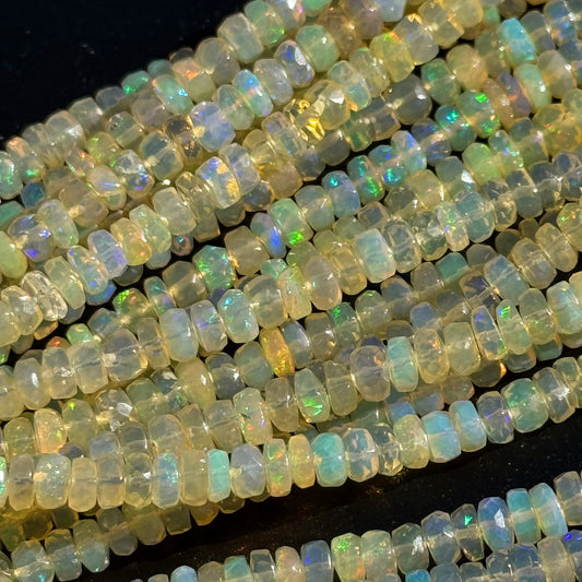 Natural precious opal displaying shifting blue, green, orange and red play-of-color as light interacts with the gemstone.