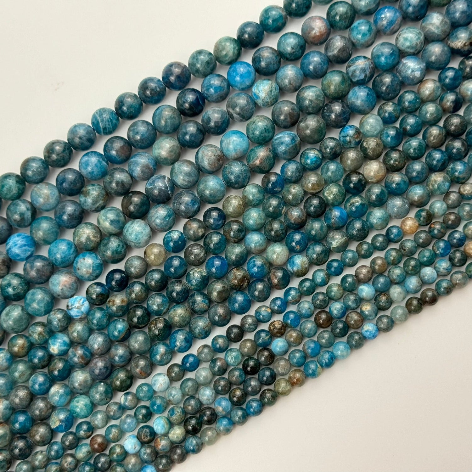 Natural Apatite gemstone beads in blue, teal, and green tones for bracelet making, necklaces, earrings, and custom jewelry designs