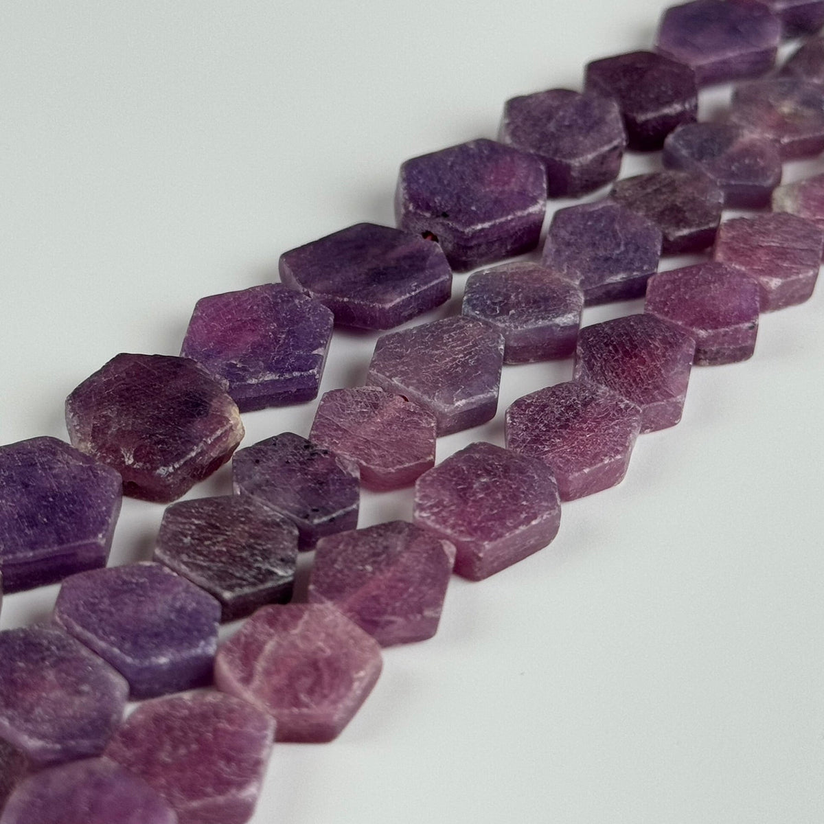 Natural hexagonal gemstone beads in multiple stones and sizes for jewelry making by Reza Gem Collection.